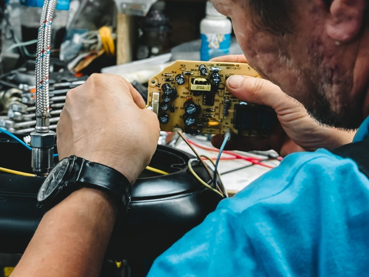Close inspection of a circuit board at the repair bench